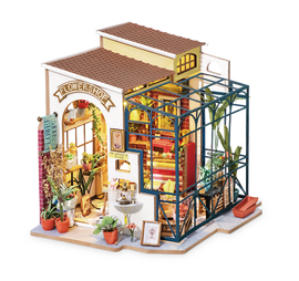 Emily's Flower Shop DIY Model Kit by Robotime, featuring a detailed miniature flower shop complete with vibrant plants, colorful interiors, and an inviting exterior. This DIY kit offers an engaging building experience for craft lovers, showcasing intricate design elements and a charming aesthetic.