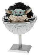 ICONX: The Child DIY kit by Metal Earth, featuring a detailed model of a small green character with large ears, seated in a futuristic pod. The model is made of metal and includes intricate design elements, making it a perfect collectible for fans.
