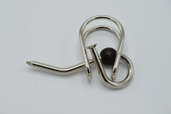 A U-Nagel mechanical puzzle by Jean-Claude Constantin, featuring intricate metal loops and a wooden bead. The design showcases a unique twisting mechanism aimed at providing mental stimulation and challenging users to find solutions. Ideal for puzzle enthusiasts and those looking for a brain teaser.