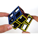 A person’s hands manipulate a Hollow Cube - Two By Two mechanical puzzle by RT18. The puzzle features vibrant colors including red, blue, yellow, and black, showcasing a unique hollow design that challenges spatial reasoning and problem-solving skills.