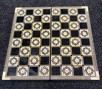 Backgammon game set featuring a beautifully crafted 12-inch board made with intricate Mother of Pearl inlays, showcasing a geometric pattern on a dark background. The board is designed for classic gameplay and is perfect for both casual and competitive play.