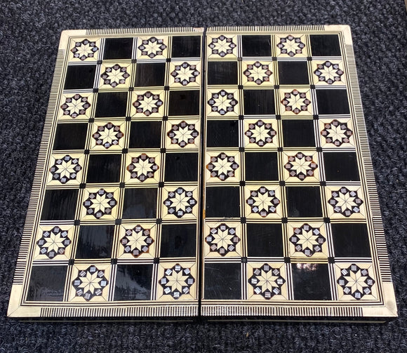 Backgammon game set featuring a beautifully crafted 12-inch board made with intricate Mother of Pearl inlays, showcasing a geometric pattern on a dark background. The board is designed for classic gameplay and is perfect for both casual and competitive play.