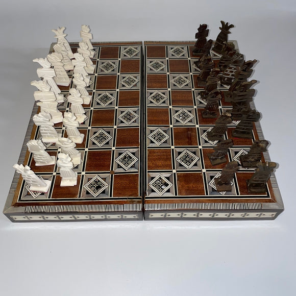 A 14-inch folding chess set featuring intricately designed pieces in two contrasting colors. The board showcases a fine wood finish with decorative inlays, ideal for both collectors and casual players. The set is compact and portable, perfect for travel and storage.
