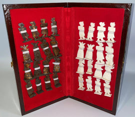 14-inch folding chess set by Mabrouk Imports featuring intricately designed pieces made of contrasting materials resting on a plush red velvet interior. The set is elegantly housed in a wooden folding case, showcasing both the white and bronze pieces ready for an engaging game.