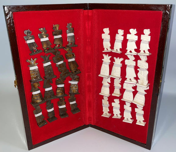 14-inch folding chess set by Mabrouk Imports featuring intricately designed pieces made of contrasting materials resting on a plush red velvet interior. The set is elegantly housed in a wooden folding case, showcasing both the white and bronze pieces ready for an engaging game.