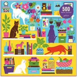 A vibrant jigsaw puzzle titled 'Curious Cats' by Galison, featuring a colorful illustration of various cats exploring a lively room filled with books, plants, and vibrant decor. The puzzle consists of 500 pieces, showcasing a whimsical and playful design that captures the curiosity of cats amidst an organized chaos.