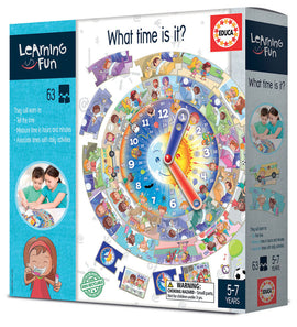 Educa's 'What Time Is It?' game box featuring a colorful clock with illustrated children engaging in various activities. The game teaches kids to tell time, measure hours and minutes, and relate time to daily activities. Suitable for children ages 5 to 7. The packaging highlights educational elements and includes images of kids playing together.