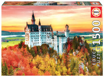 A beautifully packaged jigsaw puzzle titled 'AUTUMN IN NEUSCHWANSTEIN' by Educa. The image on the box features Neuschwanstein Castle surrounded by vibrant autumn foliage, with a scenic landscape of rolling hills and a lake in the background. The puzzle consists of 1500 pieces.