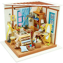 A detailed diorama of a tailor's workshop, featuring a variety of miniature furnishings and sewing materials. The scene includes a wooden table with fabric rolls, a sewing machine, colorful spools, and decorated walls with framed pictures. Brightly colored curtains and a cozy ambiance create a vibrant atmosphere for creative crafting.