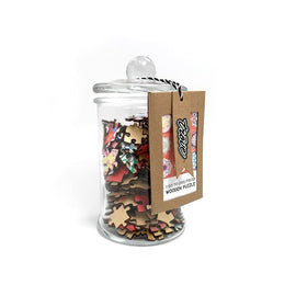 A stylish glass jar filled with colorful wooden jigsaw puzzle pieces featuring intricate mandala designs. The jar has a clear lid and a tag that states 'Trove 1 Go (250 pieces) Wooden Puzzle'. The vibrant pieces include floral and geometric patterns, ideal for puzzle enthusiasts.