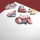 Various colorful jigsaw puzzle pieces featuring intricate mandala designs in pink, blue, and white. The pieces are made of sturdy material with rounded shapes that fit together to create a vibrant puzzle. The background is a neutral tone, allowing the vivid colors and patterns to stand out.