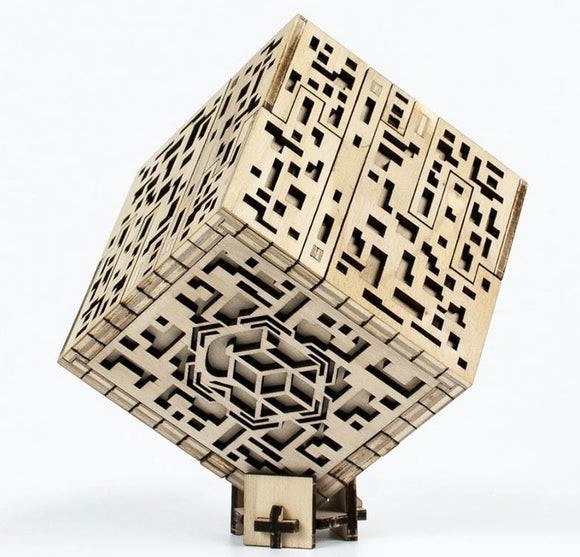 A unique Silver City Puzzle Box Kit by SAS NKD PUZZLE, featuring intricate wooden designs and a cube shape. The box displays a maze-like pattern with various cut-outs, showcasing its detailed craftsmanship. Ideal for DIY enthusiasts and puzzle lovers, this mechanical puzzle offers an engaging experience.