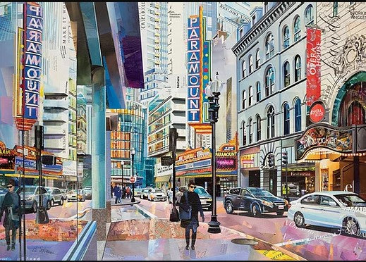 A vibrant jigsaw puzzle image titled 'Paramount Reflected' by Art & Fable Puzzle Co, showcasing a bustling city street scene. The artwork features tall buildings adorned with neon signs, including the prominent 'Paramount' marquee, and lively street activity with pedestrians and vehicles navigating the colorful scene.
