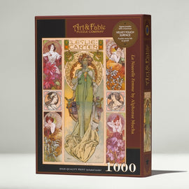 Art & Fable Puzzle Company's 'La Nouvelle Femme' jigsaw puzzle featuring elegant illustrations by Alphonse Mucha. The box showcases the intricate design, including lush floral patterns and artistic depictions of women, promising a high-quality 1000-piece experience with a velvet touch surface.