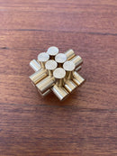 A mechanical puzzle made of brass, featuring an intricate design of cylindrical rods arranged in a cluster. The gold finish adds a touch of elegance, making it an attractive display piece as well as a challenging brain teaser.