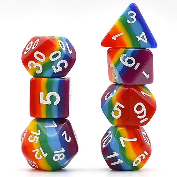 A vibrant set of opaque rainbow layer RPG dice arranged in two stacks. The set includes a variety of colorful polyhedral dice showcasing bright rainbow patterns, with clear white numbers on each side. Ideal for tabletop role-playing games.
