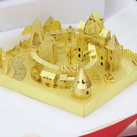 A detailed golden roller coaster model by Mu Model, featuring an intricate design with a winding track, colorful miniature buildings, trees, and a whimsical theme park layout. Ideal for DIY enthusiasts and collectors, showcasing fine craftsmanship.