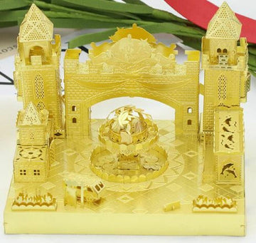 The Fantastic Castle DIY kit by Mu Model features intricately designed golden castle structures, complete with towers, archways, and a central fountain. The kit showcases elaborate details, including small windows and decorative elements, making it an eye-catching and engaging project for creative enthusiasts.