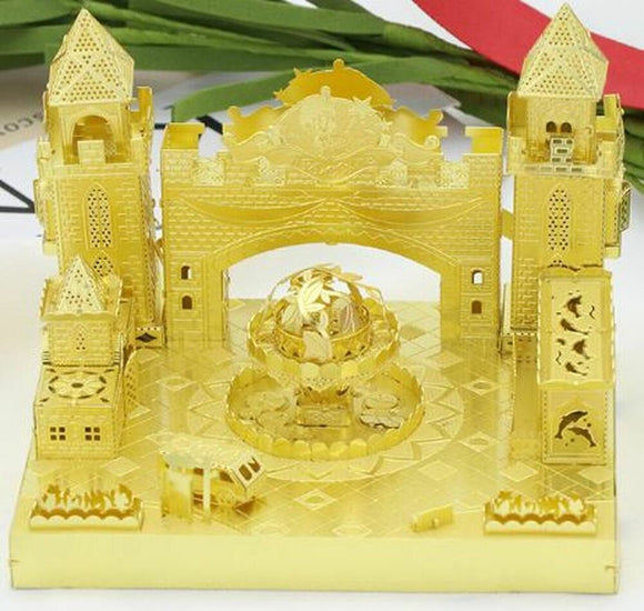 The Fantastic Castle DIY kit by Mu Model features intricately designed golden castle structures, complete with towers, archways, and a central fountain. The kit showcases elaborate details, including small windows and decorative elements, making it an eye-catching and engaging project for creative enthusiasts.