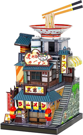 A detailed and colorful DIY model kit representing a ramen noodle shop. The structure features multiple floors with decorative signs, lanterns, and a large bowl of ramen on the roof, complete with chopsticks holding noodles. The intricate design showcases various architectural elements and vibrant colors, perfect for creative enthusiasts.