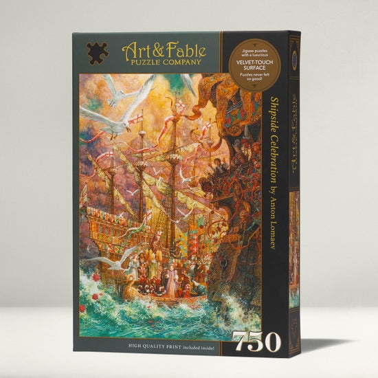 The Shipside Celebration jigsaw puzzle by Art & Fable Puzzle Co features a vibrant and detailed illustration of a festive scene on a ship, surrounded by birds and water. The box highlights that it contains 750 pieces and has a velvet-touch surface for a premium feel.