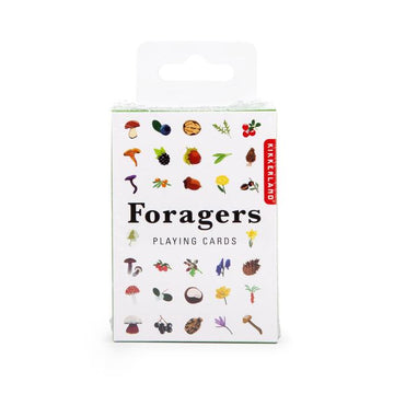 A box of Foragers Playing Cards by Kikkerland Design Inc, featuring a vibrant design with illustrations of various plants, mushrooms, and nuts. The box is predominantly white with the title 'Foragers Playing Cards' printed in bold black letters, surrounded by colorful illustrations representing foraged items.