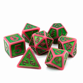 A set of seven polyhedral dice designed in vibrant pink and green colors, featuring various numbers and shapes such as a d20, d12, d10, d8, d6, and d4, perfect for tabletop gaming.