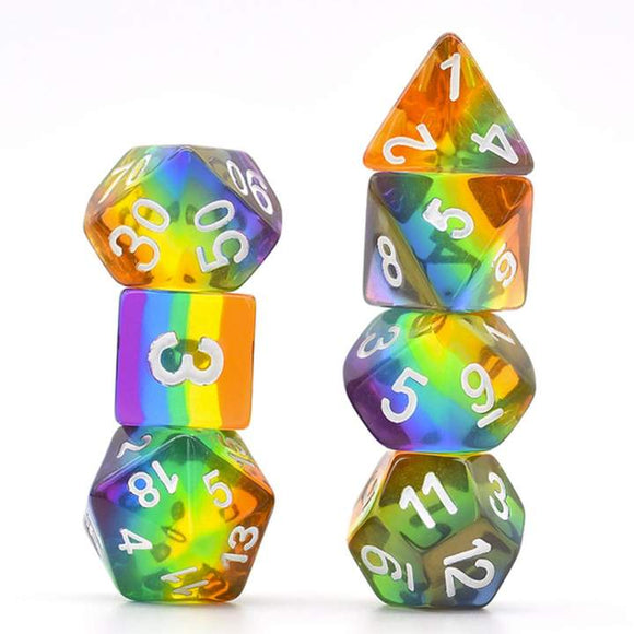 A vibrant and colorful Translucent Rainbow RPG Dice Set from Foam Brain Games. The set features various polyhedral dice, including a D20, D12, D10, D8, D6, and D4, showcasing a mesmerizing rainbow gradient with white numbers that pop against the translucent surface. Ideal for tabletop gaming enthusiasts looking to add flair to their game.