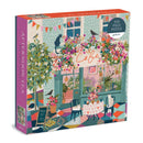 Galison Afternoon Tea 500 piece jigsaw puzzle featuring a charming café scene with vibrant flowers, playful cats, and colorful patterned flooring, perfect for puzzle enthusiasts and café lovers.