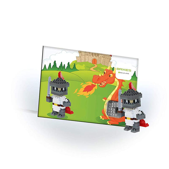 Brixies Postcard Knight kit featuring two colorful knight figures made of building blocks, with a vibrant postcard backdrop showing a dragon and a castle. The knights are poised for adventure, highlighting the creativity and fantasy theme of the DIY kit.