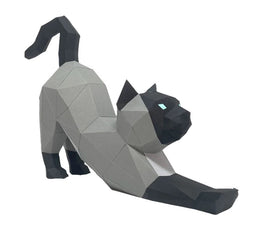 A Low Poly Craft DIY kit featuring a geometric model of a cat in a stretching pose. The cat is designed with varying shades of gray and black, showcasing a modern and artistic appearance. The model emphasizes the cat's arched back and elongated limbs, making it an ideal home decor piece or crafting project.