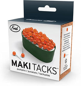 A product box for Maki Tacks Sushi Push Pins, featuring a colorful design resembling sushi with bright orange beads representing fish roe. The box is from Fred and displays a fun, quirky style that highlights its unique purpose as push pins for pinboards.