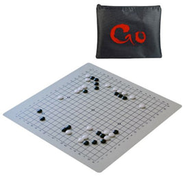 An Ultimate Go Set featuring an 18-inch silicone board with a grid pattern, accompanied by a black carrying pouch marked with a red 'Go' logo. The board displays a partially played game with black and white stones strategically placed on the grid.