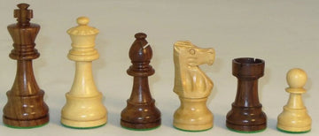 A selection of chess pieces showcasing the French style in Kikkerwood, including a 3.5-inch king, queen, knight, rook, bishop, and pawn. Each piece features a polished finish and distinct design details, highlighting the craftsmanship and elegance of the set.
