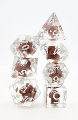 A stack of six Fluffy Puppy Polyhedral Dice featuring transparent resin with cute brown puppy designs inside, showcasing various numbered faces for gaming.