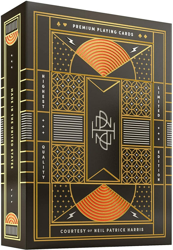 NPH Playing Cards designed by Theory 11 feature a premium gold and black packaging with intricate geometric patterns and stylized lettering. The design emphasizes quality and luxury, indicating it's a limited edition made in the United States, perfect for card enthusiasts and collectors.