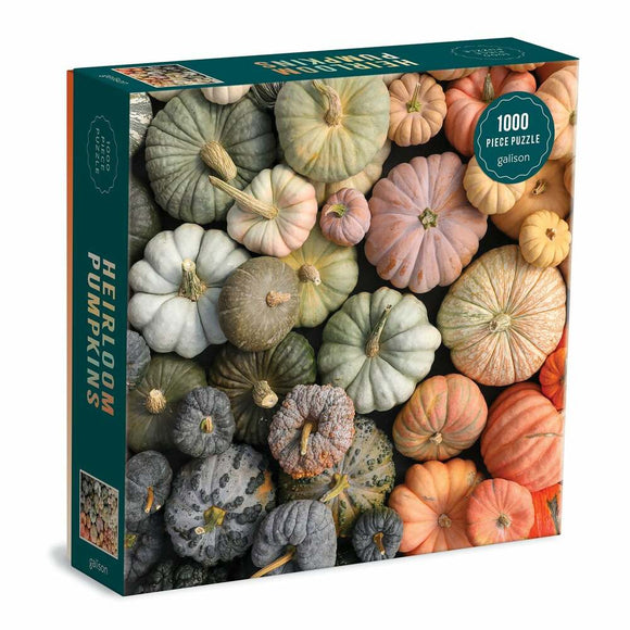 Heirloom Pumpkins Square Box puzzle featuring a variety of pumpkins in different shapes and colors, including green, gray, orange, and white. The box displays a photo of the 1000 piece puzzle, showcasing the intricate arrangement of the pumpkins.