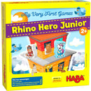 Rhino Hero Junior game box featuring colorful illustrations of friendly animal characters. The box highlights its suitability for children aged 2 and up, promoting fine motor skills, counting, and rule understanding. The vibrant design includes a building with animals like a bear, bird, and giraffe, suitable for early learning.