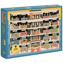 Jigsaw puzzle titled 'In the Bookstore', created by Princeton Architectural Press, featuring a whimsical illustration of various bookstore sections and characters interacting within the shelves. The puzzle consists of 1000 pieces and showcases a vibrant, detailed scene of a multi-level bookstore with genres labeled such as Fantasy, Mystery, and Young Adult.