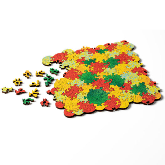 A vibrant jigsaw puzzle titled 'Baffling Bubbles Jungle Foliage' made by Nervous System. The puzzle features an array of interlocking pieces in lively colors of red, yellow, green, and blue, some pieces scattered around the partially completed design.