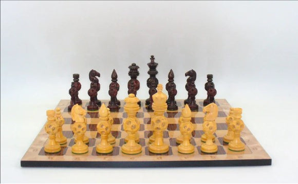 A beautifully crafted chess set featuring 5-inch king rosewood concentric ball chess pieces. The board displays alternating light and dark squares, with intricate and detailed carvings on the pieces, showcasing elegance and style. The set is arranged for an engaging game of chess, highlighting the thoughtful design and artistry of WorldWise Imports.