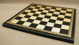 A stylish 13-inch pressed black and gold leather chess board featuring a classic checkered design with ornate golden detailing along the edges, enhancing its elegant look and feel.