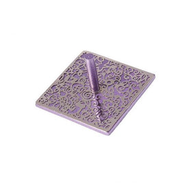 Purple laser cut dreidel intricately designed with swirling patterns. The eight-sided top is cylindrical, standing prominently on a square base, perfect for family games during Hanukkah.