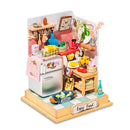 A beautifully crafted DIY model kit titled 'Taste Life Kitchen' by Robotime. This miniature kitchen scene features a shiny silver fridge, a variety of colorful fruits and vegetables on display, shelves adorned with kitchen tools, and a charming tiled floor. Perfect for those who enjoy intricate crafting and home decor.