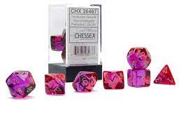 Chessex Gemini Translucent Red, Violet, and Gold 7 Polyhedral dice set. The set includes various shapes, like d20, d12, and d4, displayed in a clear packaging for tabletop gaming.