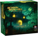 Betrayal at House on the Hill 2nd Edition board game box featuring an eerie haunted house surrounded by foreboding trees and a misty atmosphere. The box shows the title prominently with light spilling from the windows, and includes information on player count and playing time.