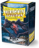 Dragon Shield card sleeves in black matte finish, featuring an artistic depiction of a dragon on the packaging. The box contains 100 standard size card sleeves, designed to protect trading cards with style.