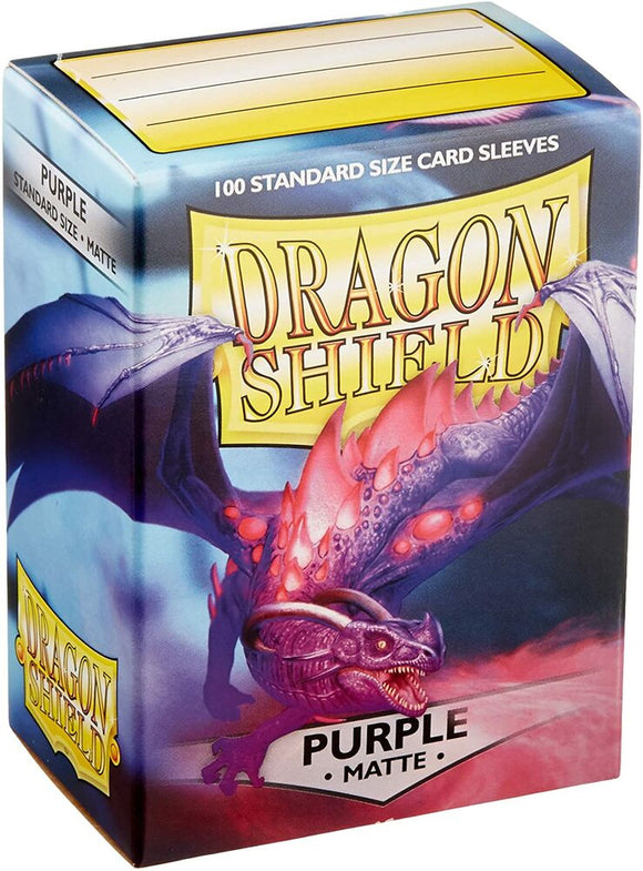 A vibrant package of Dragon Shields: Matte Purple card sleeves featuring an illustrated purple dragon on the front. The box contains 100 standard size card sleeves designed to protect cards with a matte finish, ideal for card games.