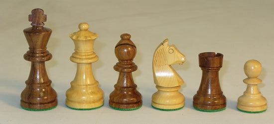A collection of six chess pieces including a 3-inch king made of acacia wood and boxwood. The set features intricately designed pieces, highlighting the craftsmanship and quality materials used. The chess pieces are displayed in a line on a neutral background, showcasing the contrasting colors of the wood.
