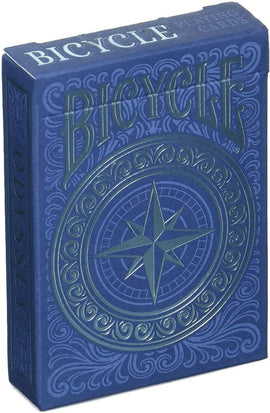Bicycle Odyssey Card Deck by US Playing Card Co., featuring an intricately designed blue box with a compass motif and decorative details. Perfect for card games and magic tricks.